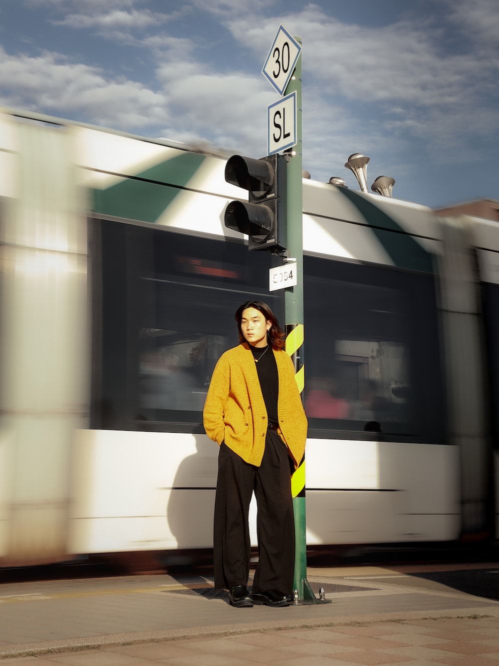 ブラック系のその他トップス、オレンジ系のカーディガン/ボレロ、ブラック系のチノパンツを着用したメンズの冬コーディネートの2枚目の写真