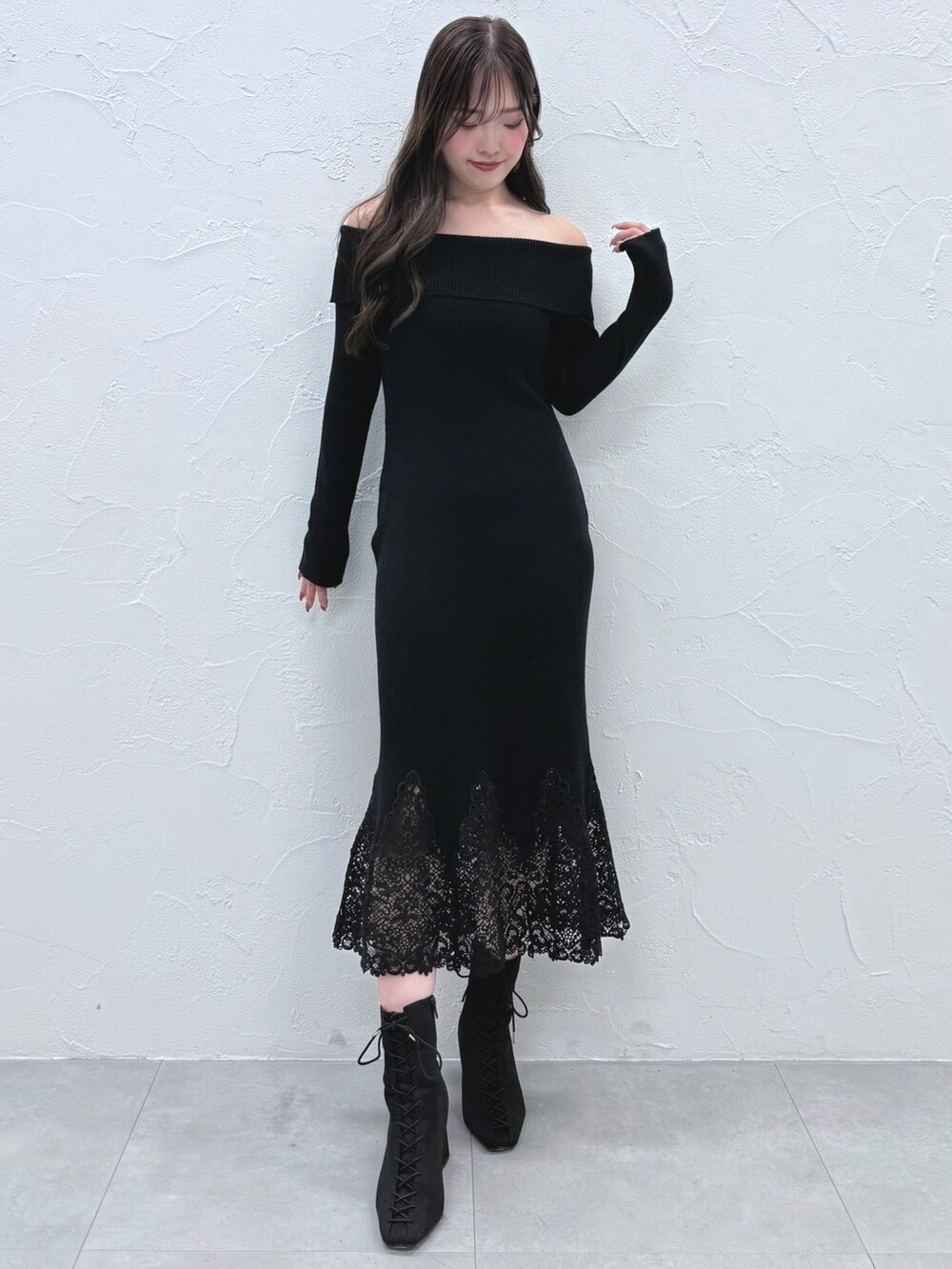 ブラック系のワンピース、ブラック系のブーツを着用したレディースの秋コーディネートの2枚目の写真