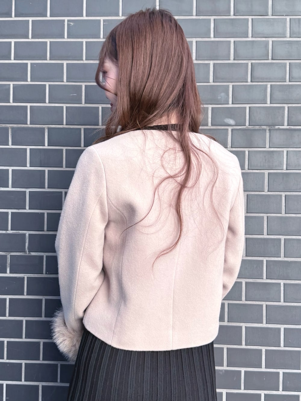 ブラック系のブーツ、ブラック系のワンピース、ベージュ系のショルダーバッグを着用したレディースの冬コーディネートの7枚目の写真