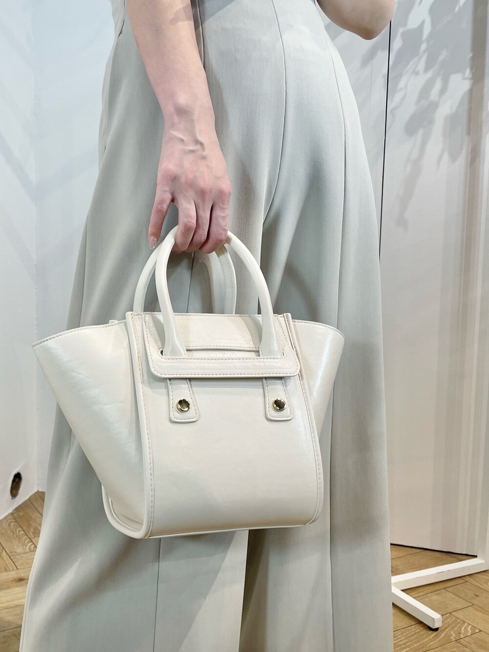 ホワイト系のトートバッグ、ホワイト系のサンダル、グリーン系のその他パンツを着用したレディースの夏コーディネートの9枚目の写真