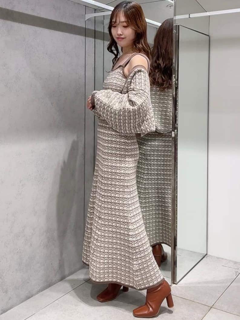 ブラウン系のブーツ、ベージュ系のジャンパースカート、ベージュ系のカーディガン/ボレロを着用したレディースの秋コーディネートの2枚目の写真