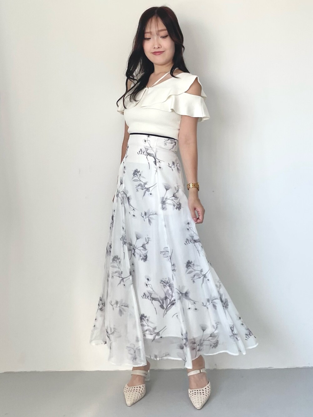 ホワイト系のスカート、パープル系のトレンチコート、ホワイト系のニット/セーターを着用したレディースの冬コーディネートの6枚目の写真