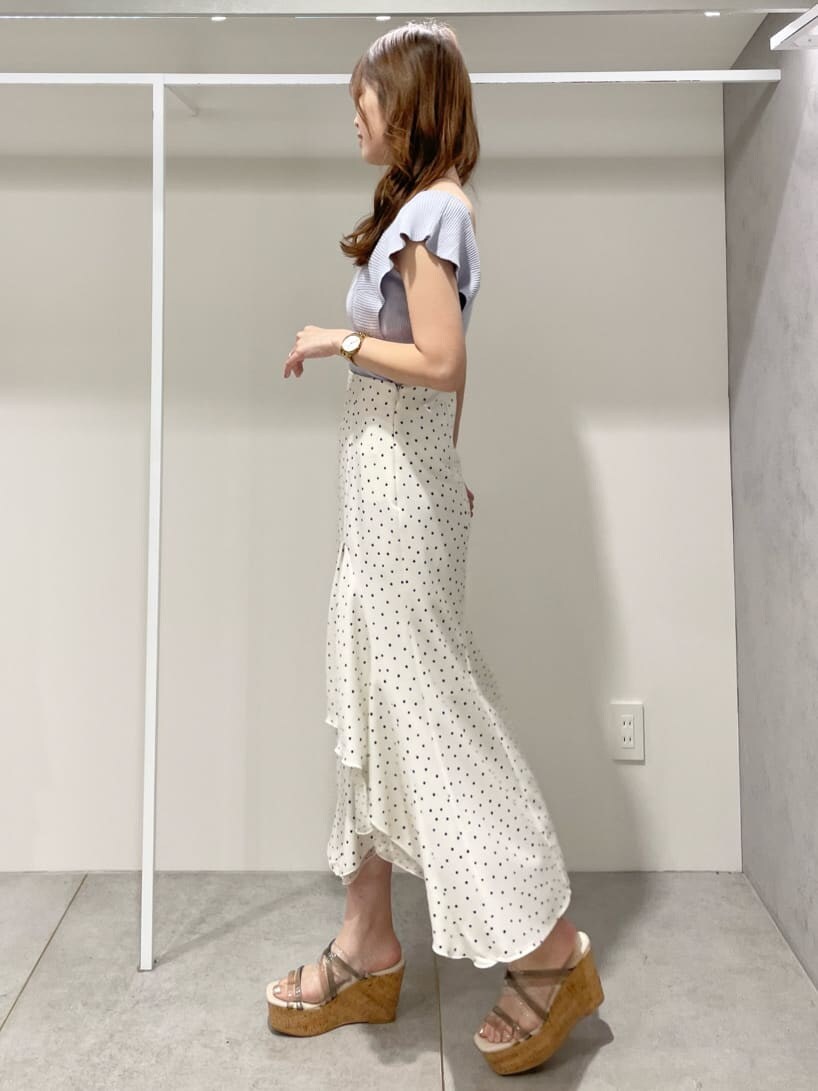 ホワイト系のスカート、グリーン系のサンダル、ブルー系のニット/セーターを着用したレディースの春コーディネートの2枚目の写真