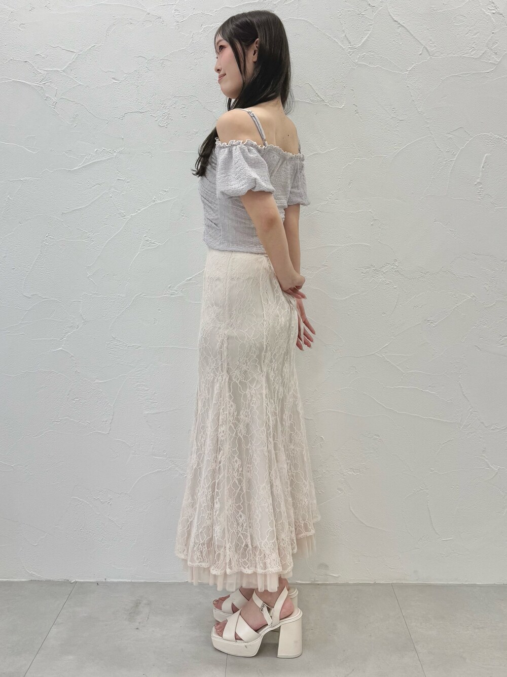 ホワイト系のスカート、ホワイト系のサンダル、パープル系のTシャツ/カットソーを着用したレディースの夏コーディネートの3枚目の写真