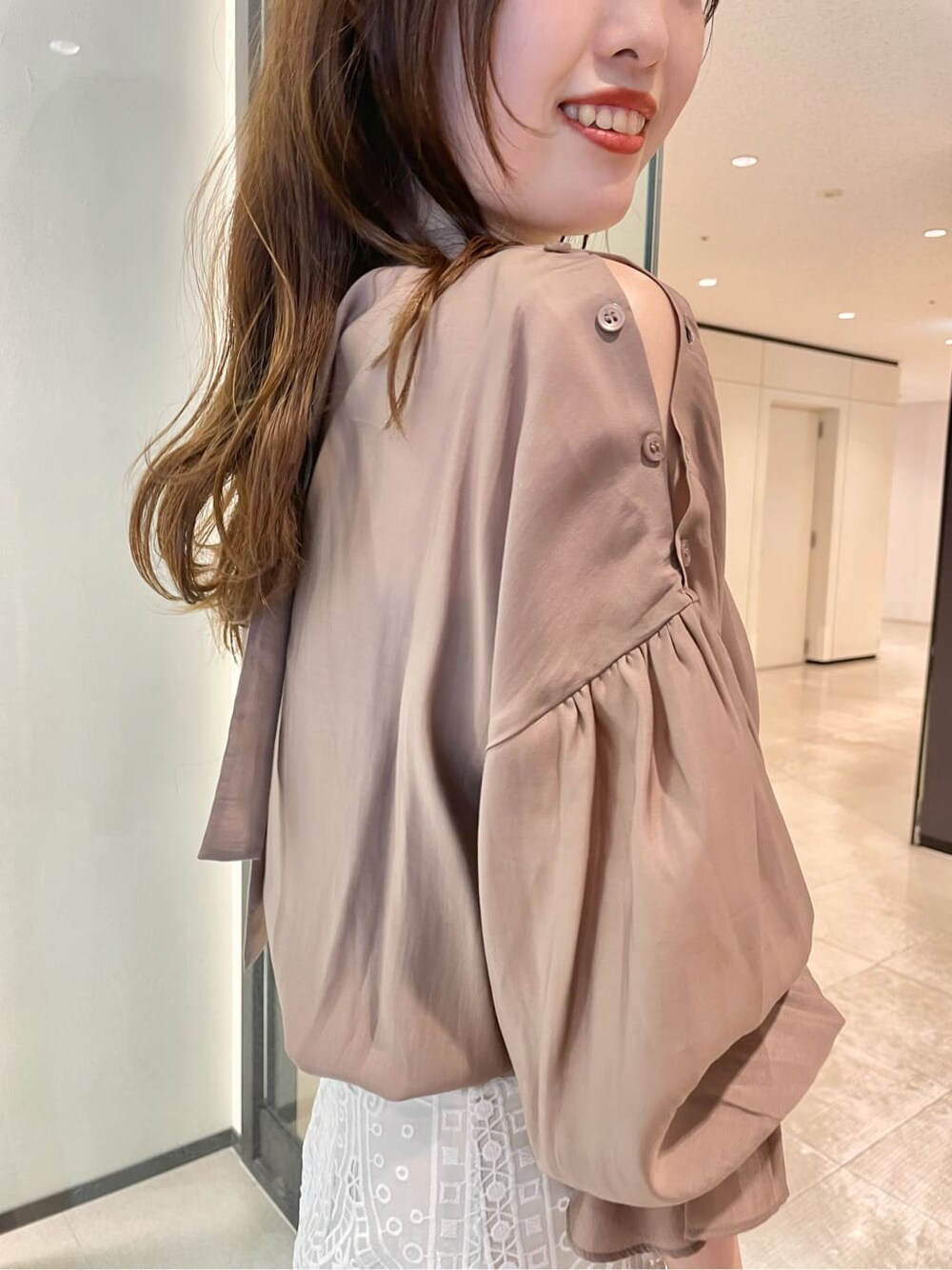 ピンク系のシャツ/ブラウス、ホワイト系のスカート、ベージュ系のパンプスを着用したレディースの夏コーディネートの3枚目の写真