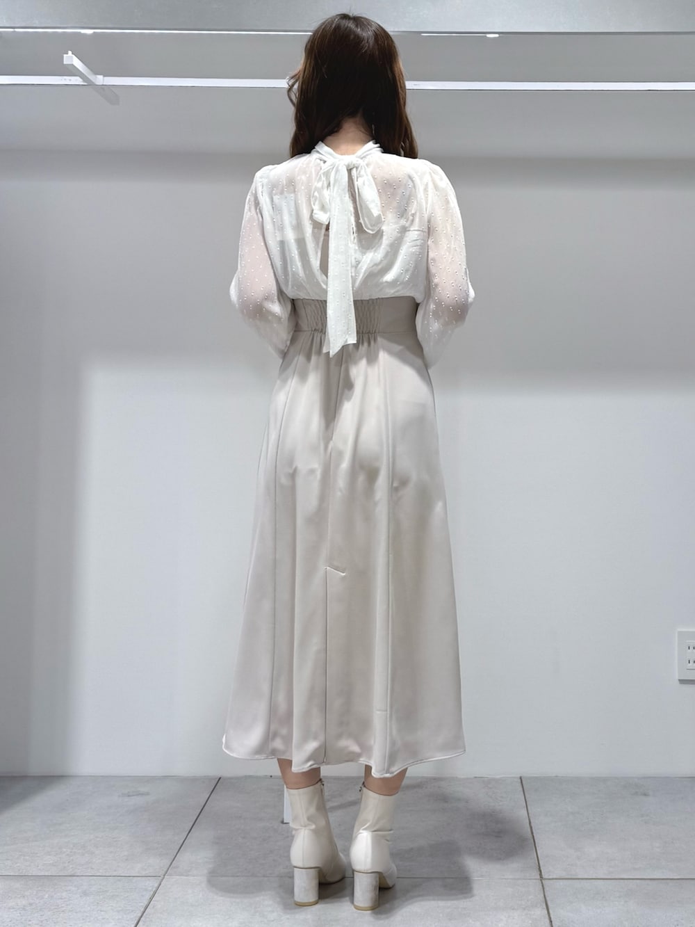 ホワイト系のワンピース、ホワイト系のブーツを着用したレディースの冬コーディネートの4枚目の写真