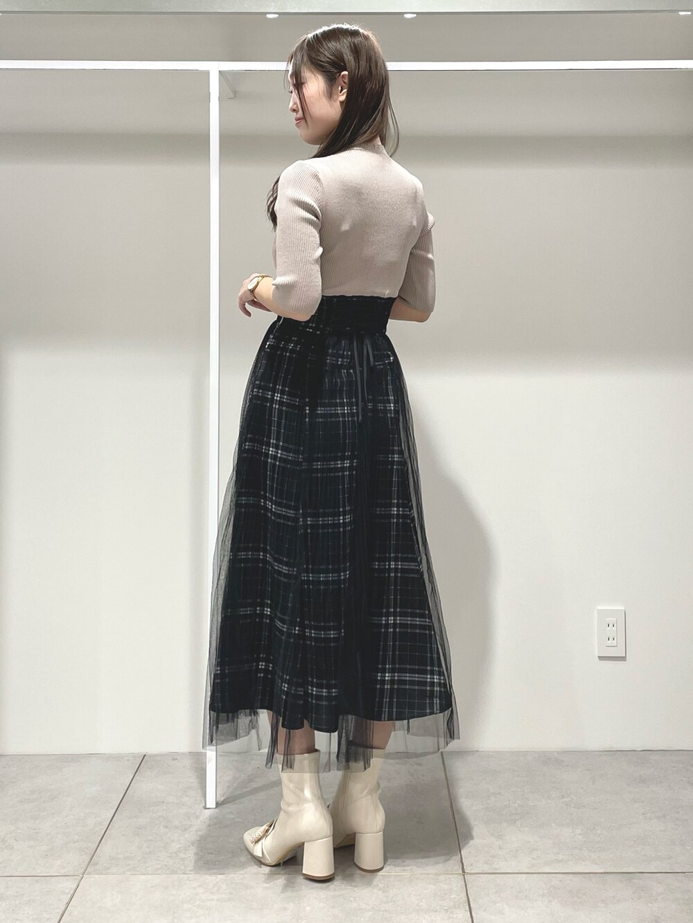 ベージュ系のワンピース、ピンク系のトレンチコート、ホワイト系のブーツを着用したレディースの春コーディネートの8枚目の写真