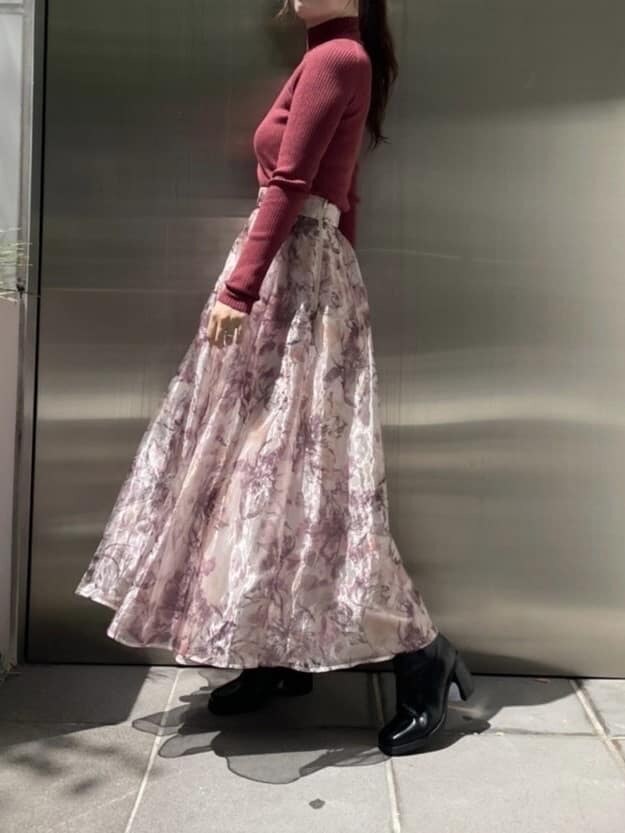 ホワイト系のハンドバッグ、ブラウン系のチェスターコート、レッド系のニット/セーターを着用したレディースの秋コーディネートの7枚目の写真