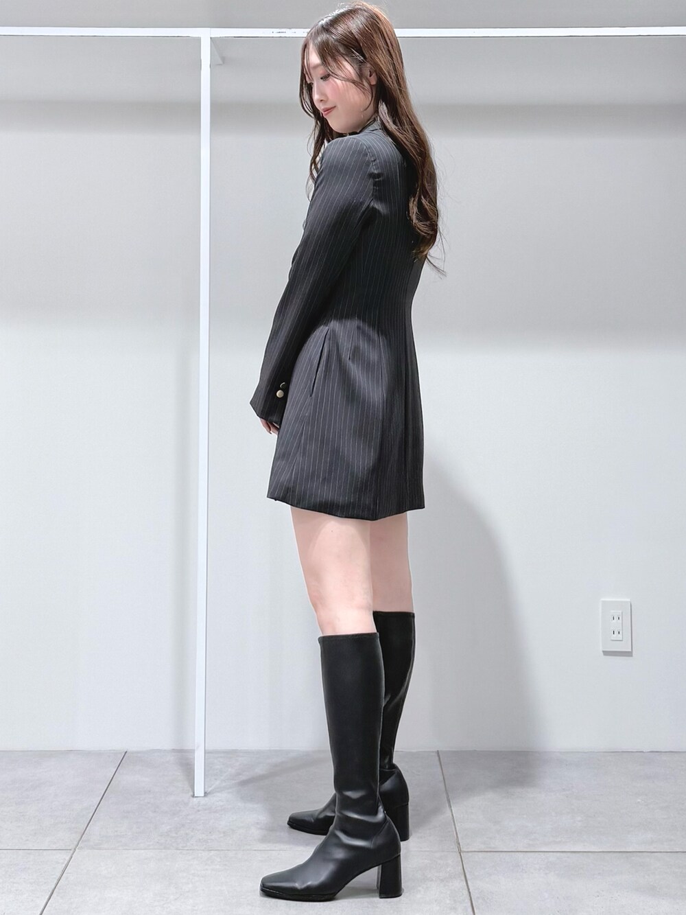 ブラック系のブーツ、グレー系のワンピースを着用したレディースの夏コーディネートの3枚目の写真