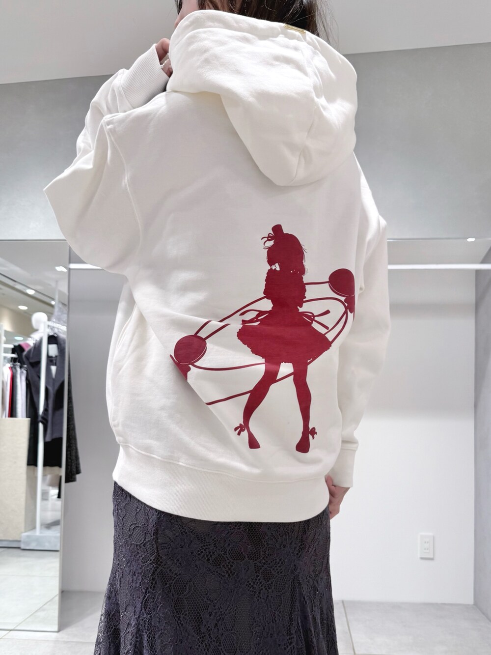 ホワイト系のパーカー、グレー系のスカート、ブラック系のブーツを着用したレディースの冬コーディネートの5枚目の写真