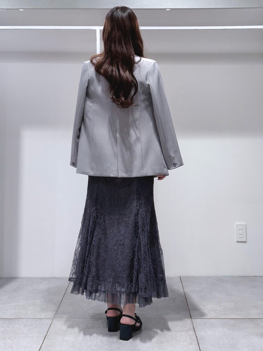 グレー系のシャツ/ブラウス、グレー系のスカート、ブルー系のパンプスを着用したレディースの春コーディネートの4枚目の写真