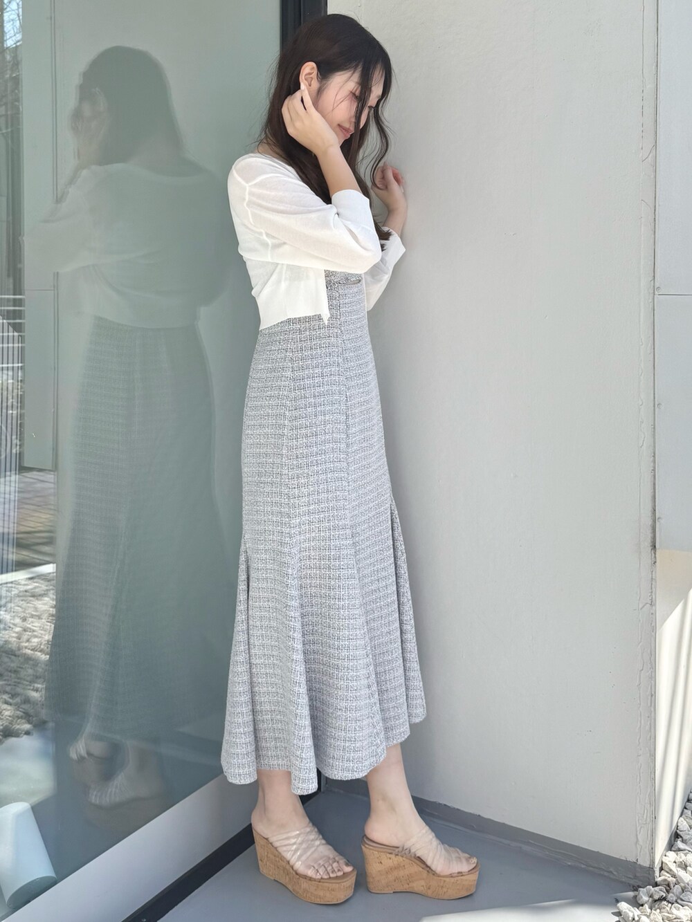 グレー系のワンピース、ホワイト系のカーディガン/ボレロ、その他のサンダルを着用したレディースの春コーディネートの3枚目の写真