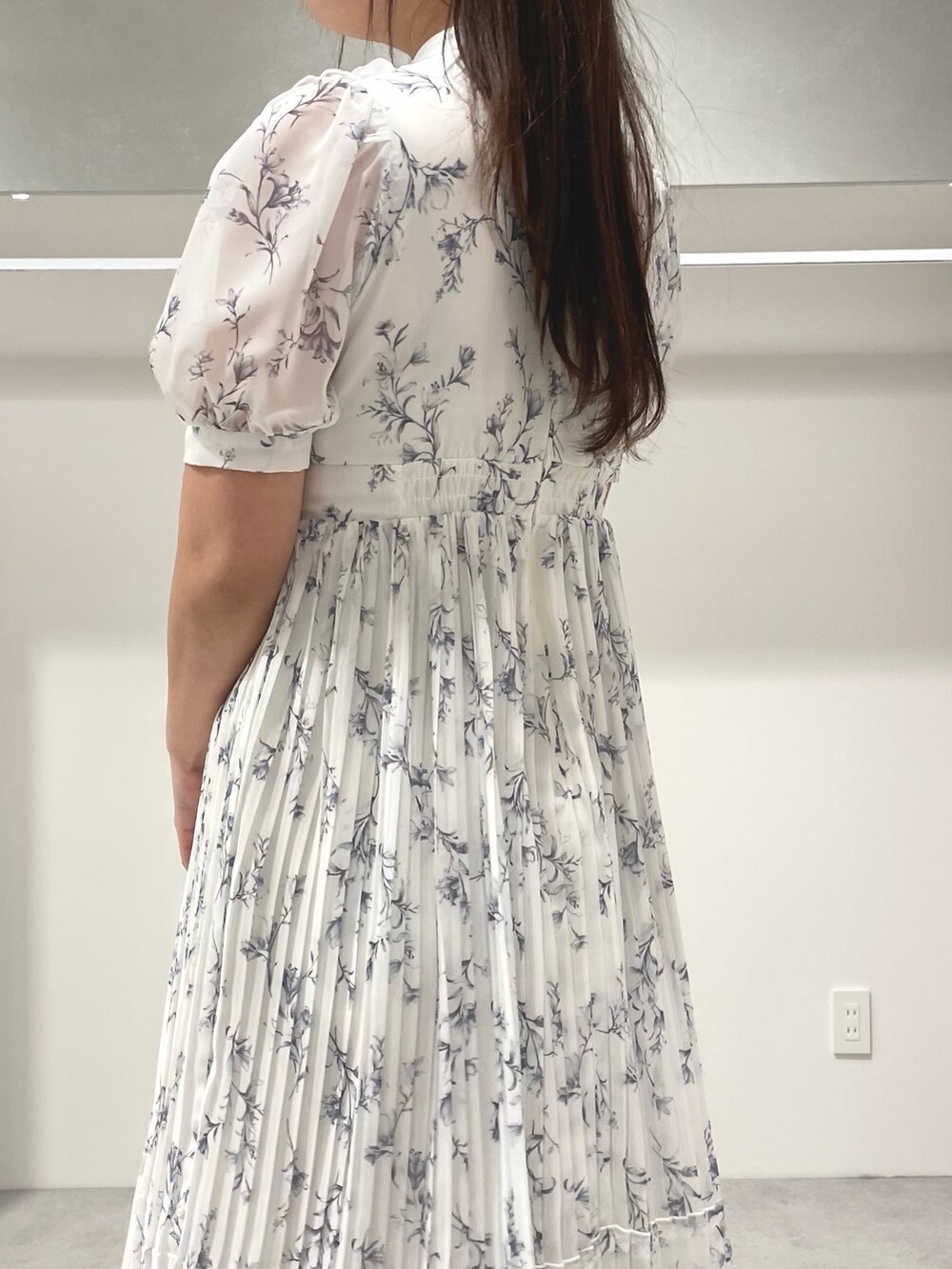 ホワイト系のトレンチコート、ホワイト系のワンピース、シルバー系のパンプスを着用したレディースの春コーディネートの7枚目の写真