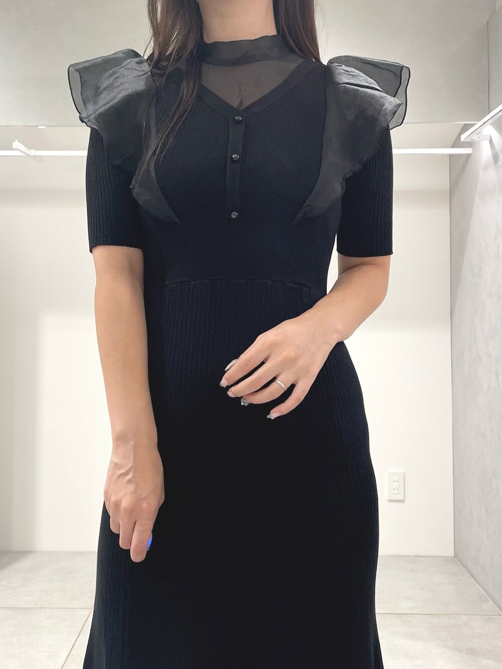 ブラック系のワンピース、ブラック系のハンドバッグ、ブラック系のブーツを着用したレディースの秋コーディネートの5枚目の写真