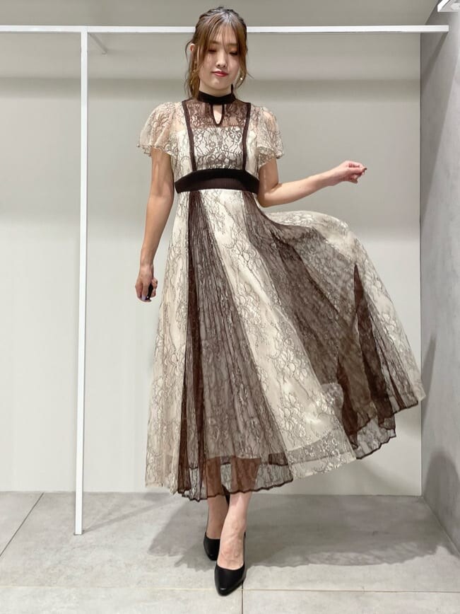 ブラック系のパンプス、ホワイト系のワンピース、ベージュ系のカーディガン/ボレロを着用したレディースの秋コーディネートの5枚目の写真