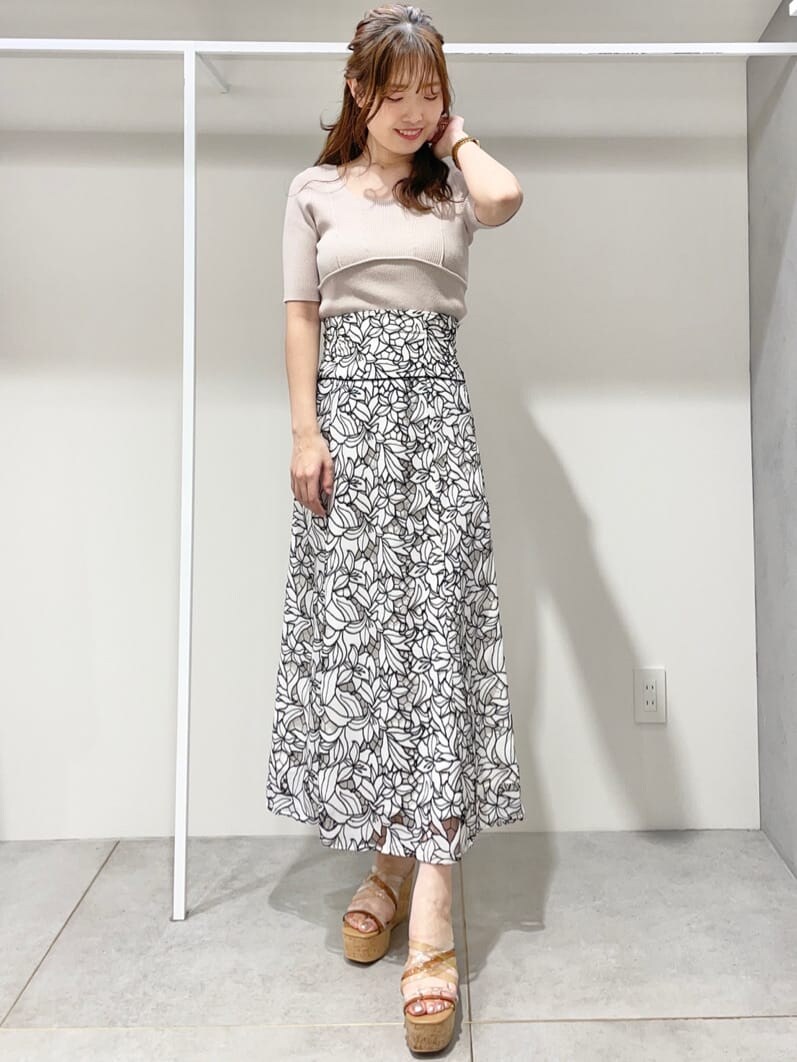 ベージュ系のニット/セーター、ベージュ系のサンダル、ブラック系のスカートを着用したレディースの春コーディネートの6枚目の写真