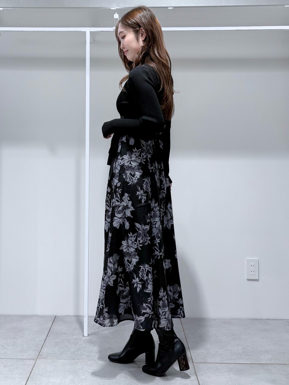 ブラック系のワンピース、ブラック系のブーツを着用したレディースの冬コーディネートの4枚目の写真