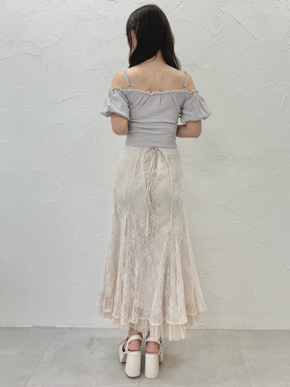 ホワイト系のスカート、ホワイト系のサンダル、パープル系のTシャツ/カットソーを着用したレディースの夏コーディネートの4枚目の写真