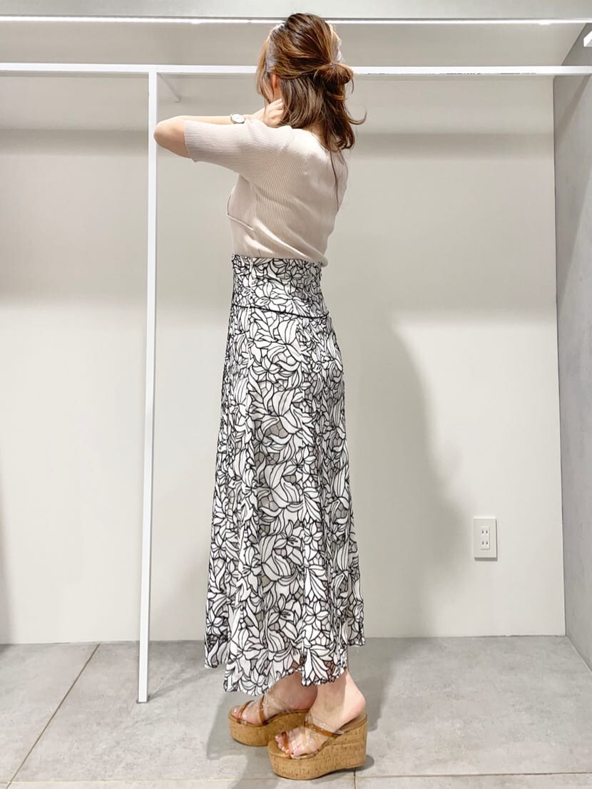 ベージュ系のニット/セーター、ベージュ系のサンダル、ブラック系のスカートを着用したレディースの春コーディネートの7枚目の写真