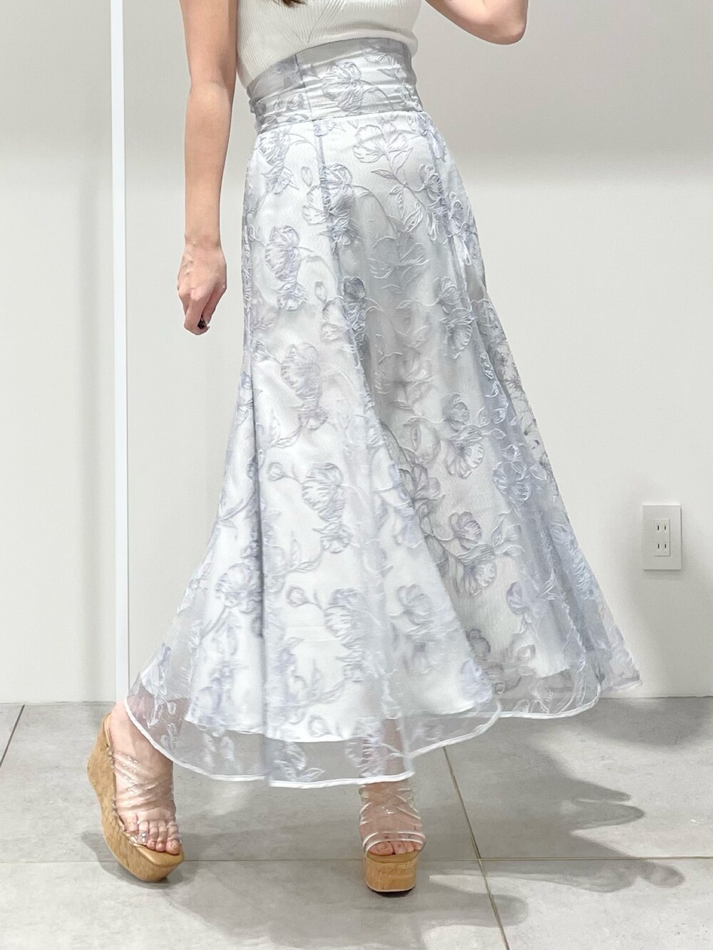 ホワイト系のニット/セーター、ブルー系のスカート、その他のサンダルを着用したレディースの春コーディネートの7枚目の写真