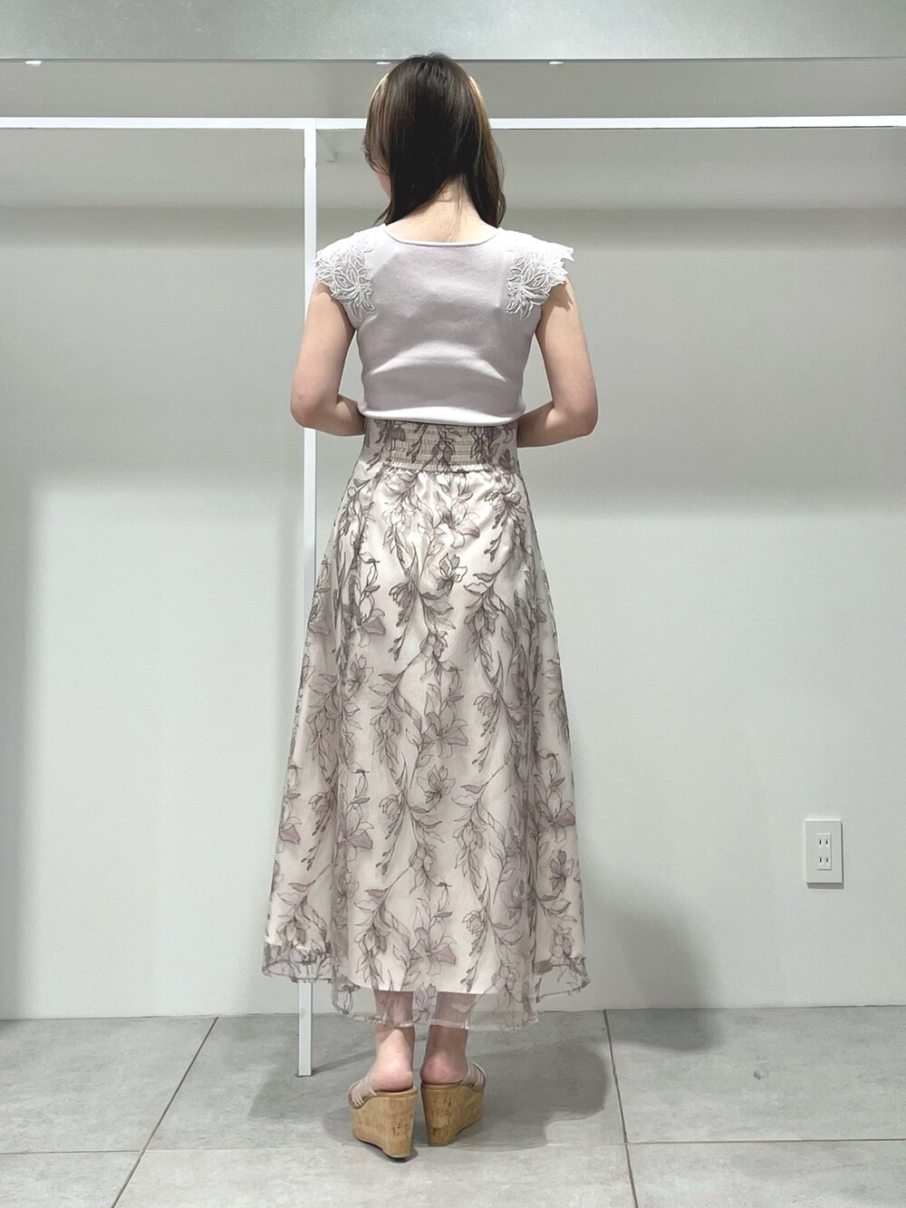 ブラウン系のトートバッグ、ピンク系のスカート、その他のサンダルを着用したレディースの夏コーディネートの3枚目の写真