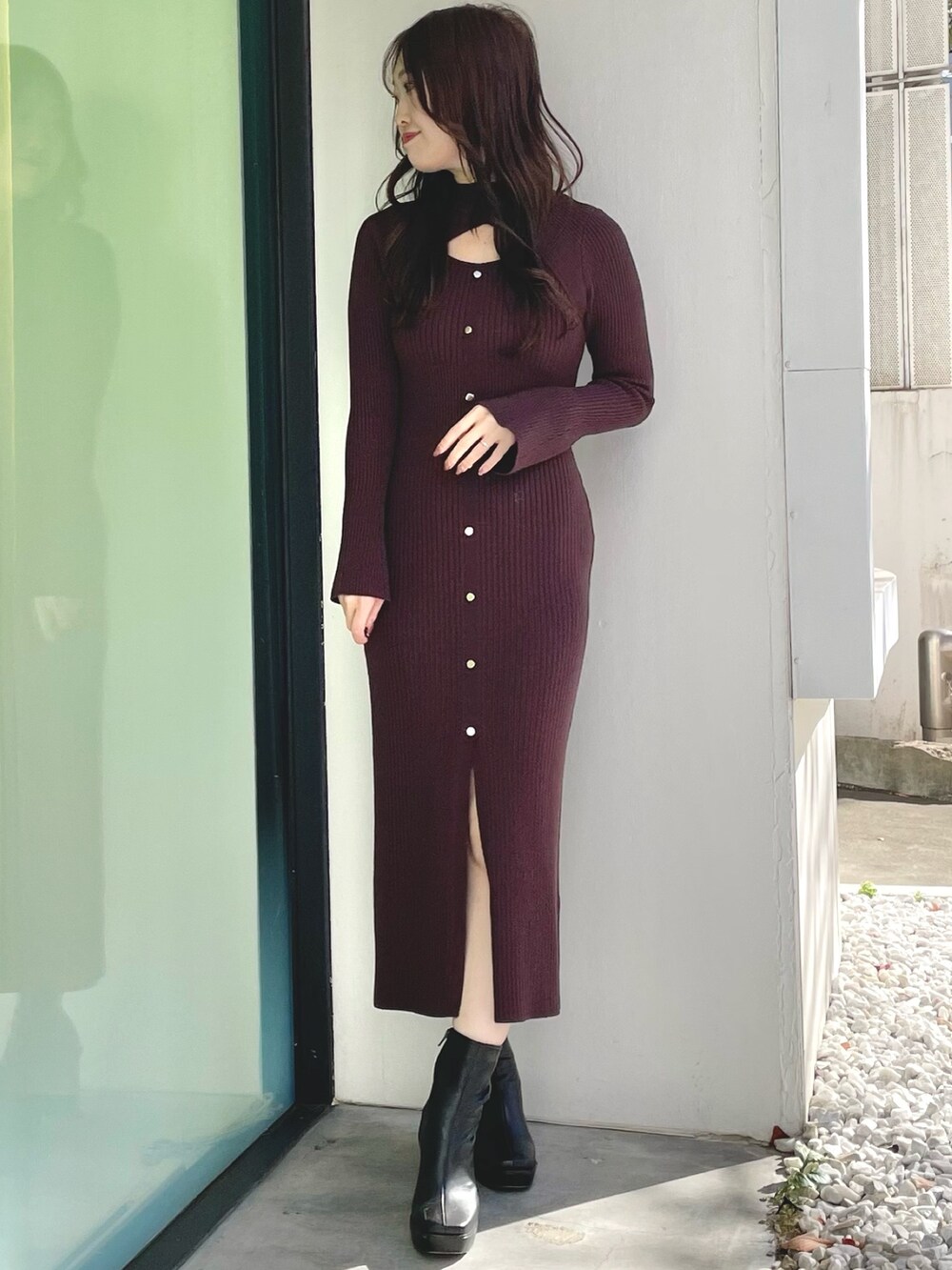 ブラック系のダウンジャケット/コート、ブラウン系のワンピース、ブラック系のブーツを着用したレディースの冬コーディネートの5枚目の写真