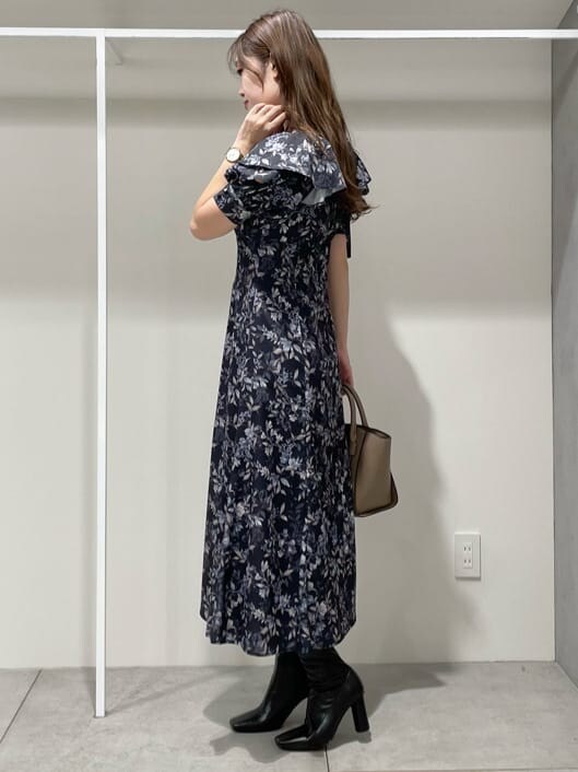 ブルー系のワンピース、ブラック系のブーツ、ブラウン系のハンドバッグを着用したレディースの秋コーディネートの4枚目の写真