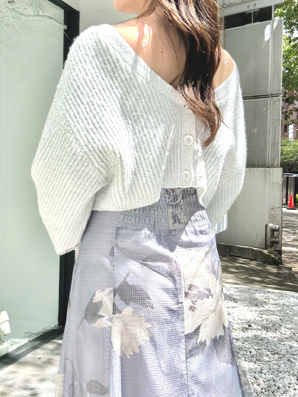 ブルー系のカーディガン/ボレロ、ブルー系のスカート、ブラック系のブーツを着用したレディースの秋コーディネートの6枚目の写真