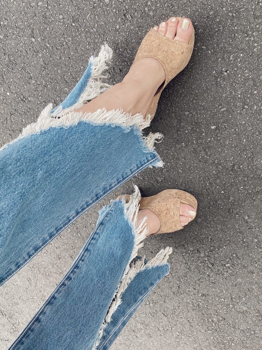 ブルー系のデニムパンツ、パープル系のタンクトップを着用したレディースの夏コーディネートの7枚目の写真