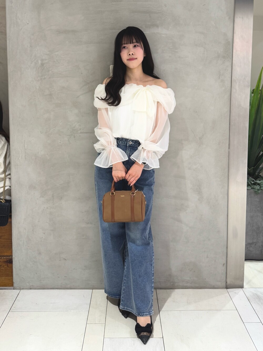 ホワイト系のシャツ/ブラウス、ブルー系のデニムパンツ、イエロー系のボストンバッグを着用したレディースの春コーディネートの6枚目の写真