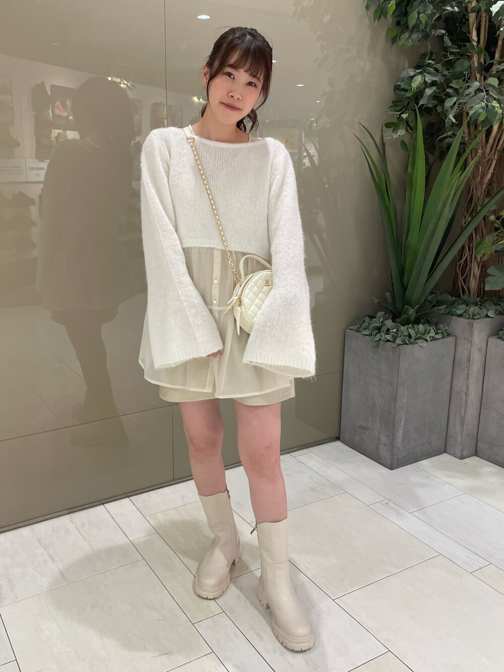 ホワイト系のニット/セーター、ホワイト系のチュニック、ホワイト系のスカートを着用したレディースの秋コーディネートの2枚目の写真