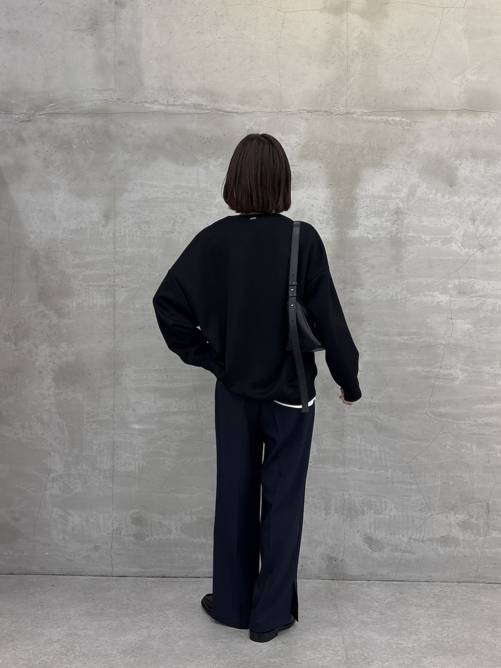 ブラック系のTシャツ/カットソー、ブルー系のスラックス、ホワイト系のシャツ/ブラウスを着用したレディースの冬コーディネートの3枚目の写真