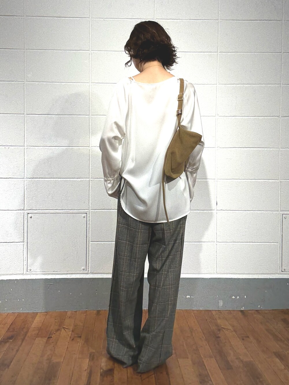 グレー系のスラックス、ベージュ系のショルダーバッグ、ホワイト系のシャツ/ブラウスを着用したレディースの夏コーディネートの3枚目の写真