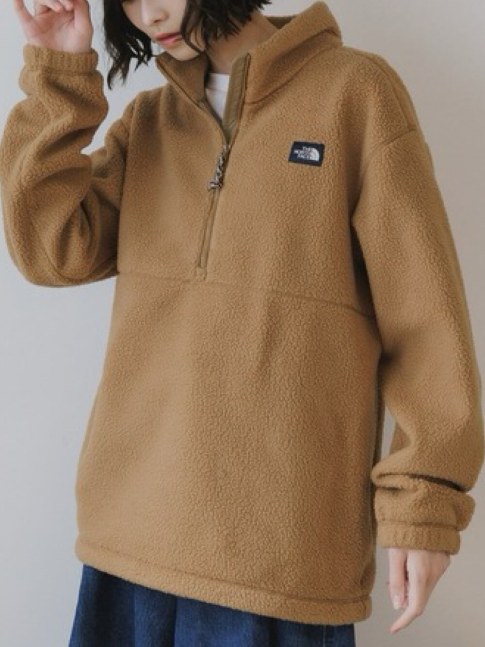 ブラウン系のブルゾン、ブルー系のデニムパンツ、ホワイト系のTシャツ/カットソーを着用したレディースの秋コーディネートの2枚目の写真