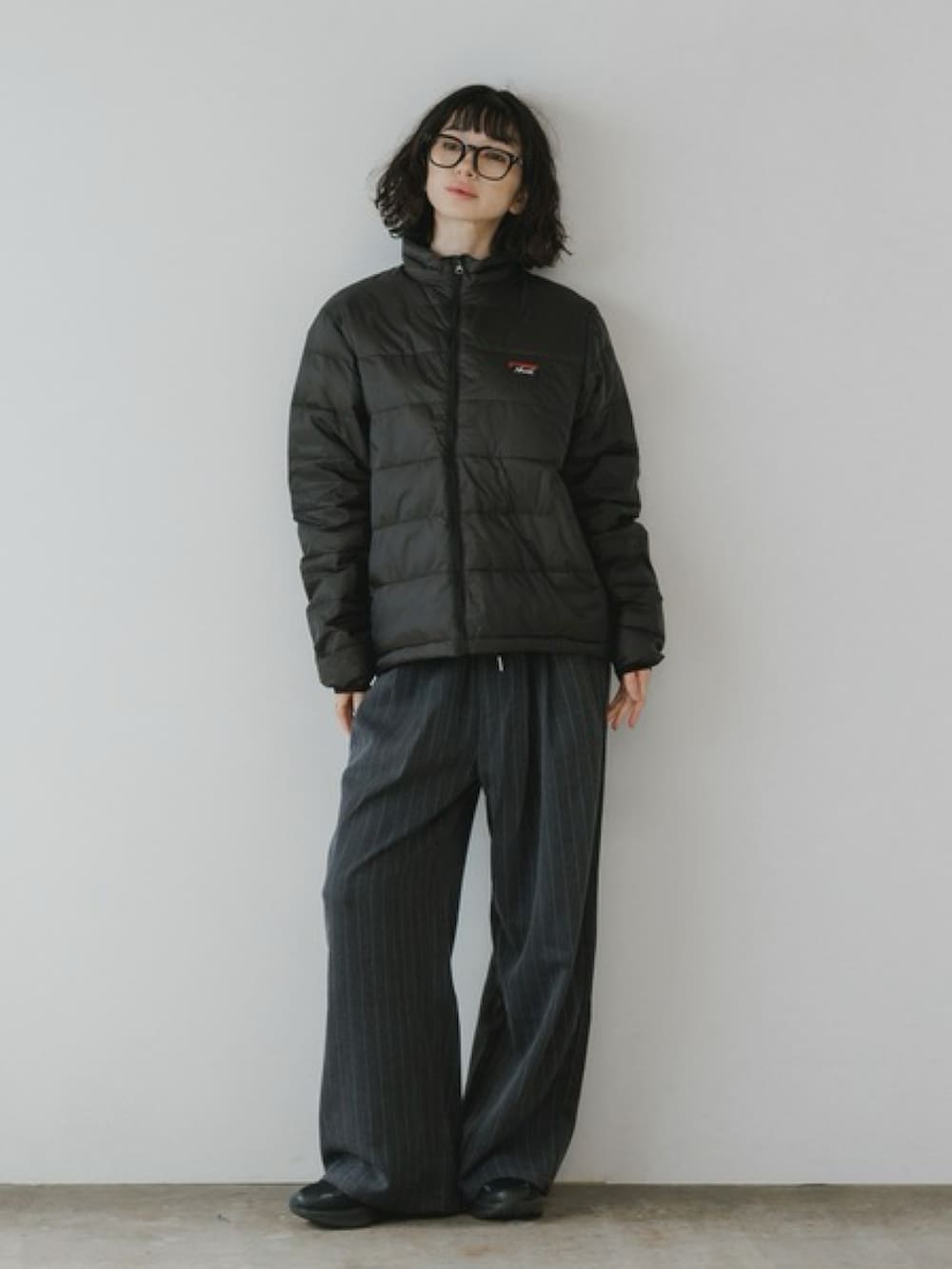 ブラック系のダウンジャケット/コート、ホワイト系のスウェットを着用したレディースの冬コーディネートの2枚目の写真