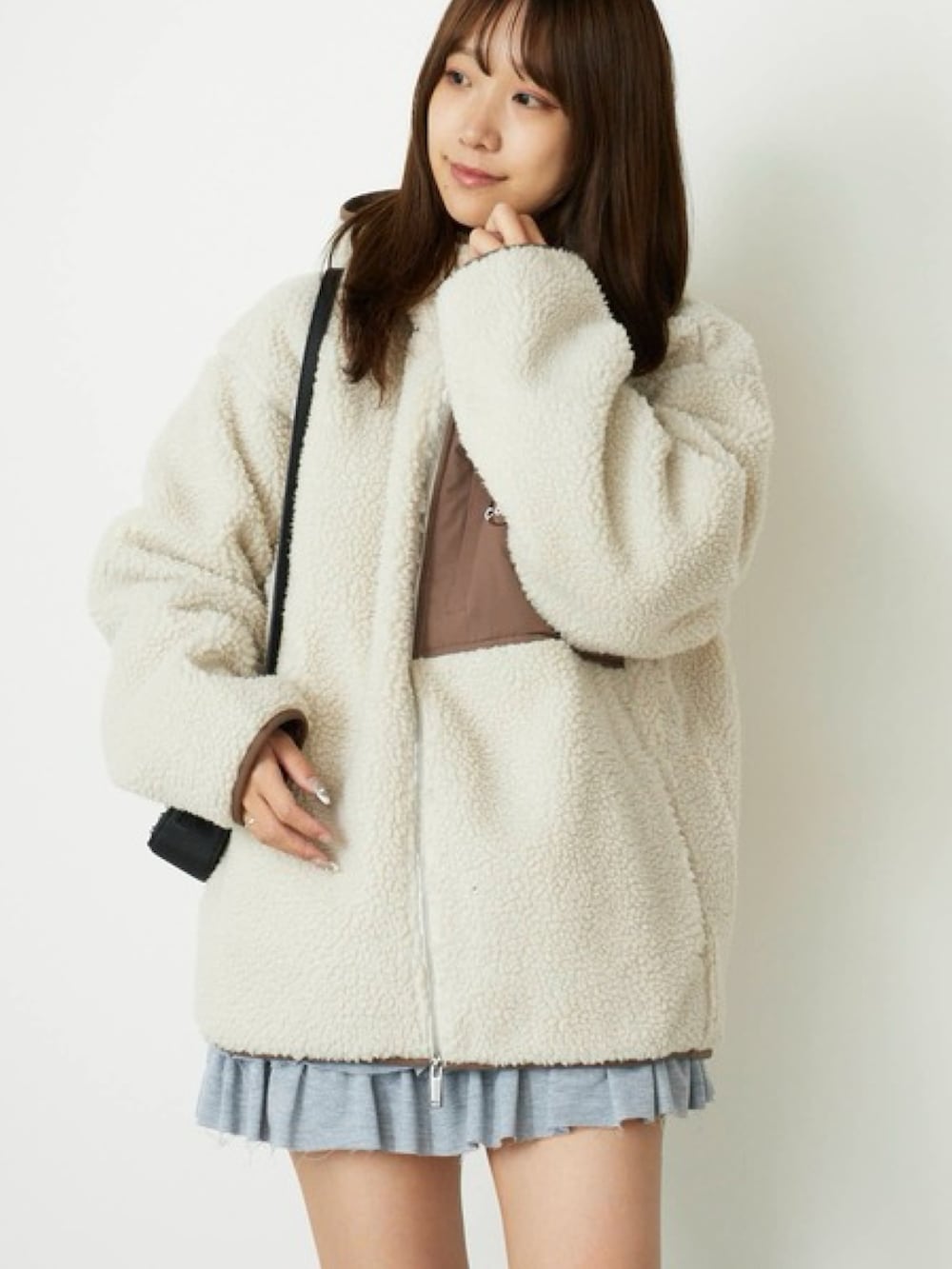 グレー系のスウェット、グレー系のスカート、ベージュ系のブルゾンを着用したレディースの秋コーディネートの3枚目の写真