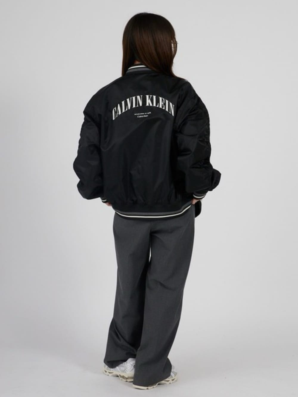 ブラック系のブルゾン、ホワイト系のTシャツ/カットソーを着用したレディースの春コーディネートの2枚目の写真