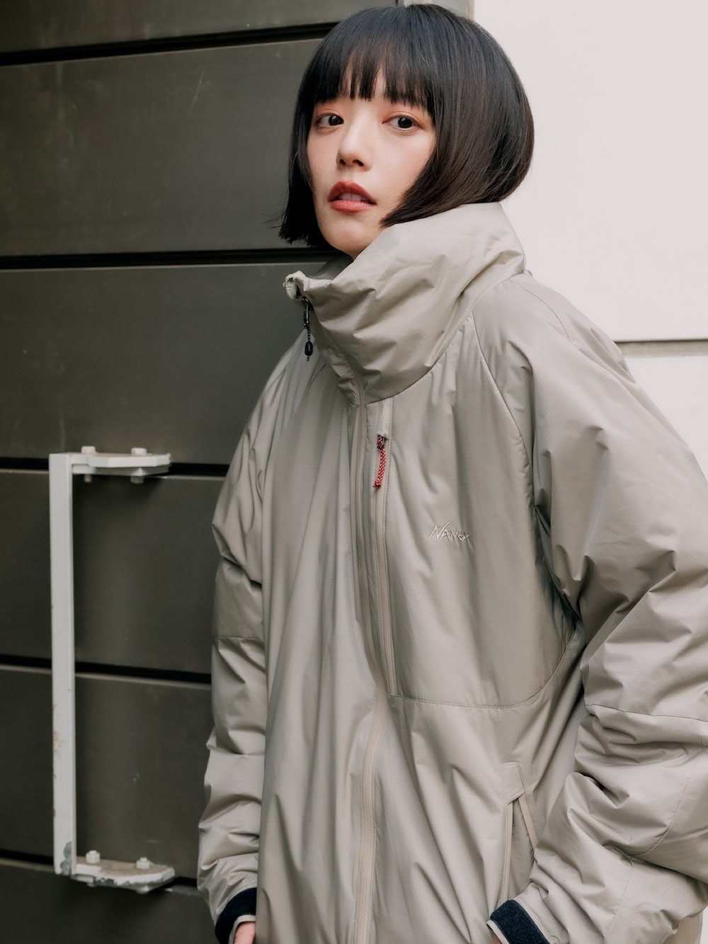 ベージュ系のダウンジャケット/コート、ホワイト系のスウェット、ブルー系のデニムパンツを着用したレディースの冬コーディネートの5枚目の写真