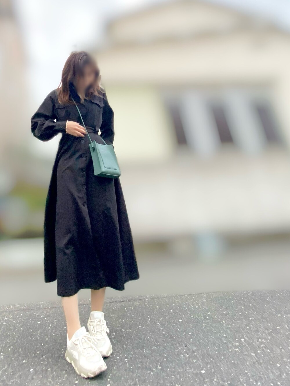 ブラック系のワンピース、グリーン系のショルダーバッグ、ベージュ系のTシャツ/カットソーを着用したレディースの春コーディネートの2枚目の写真