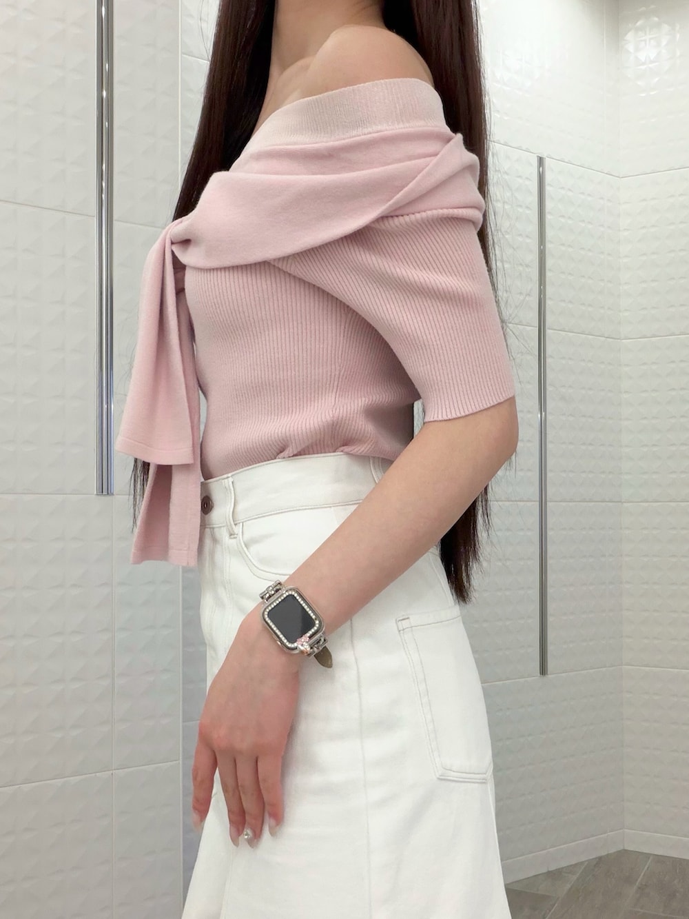 ホワイト系のスカート、ブラウン系のハンドバッグ、ブラウン系のパンプスを着用したレディースの春コーディネートの5枚目の写真