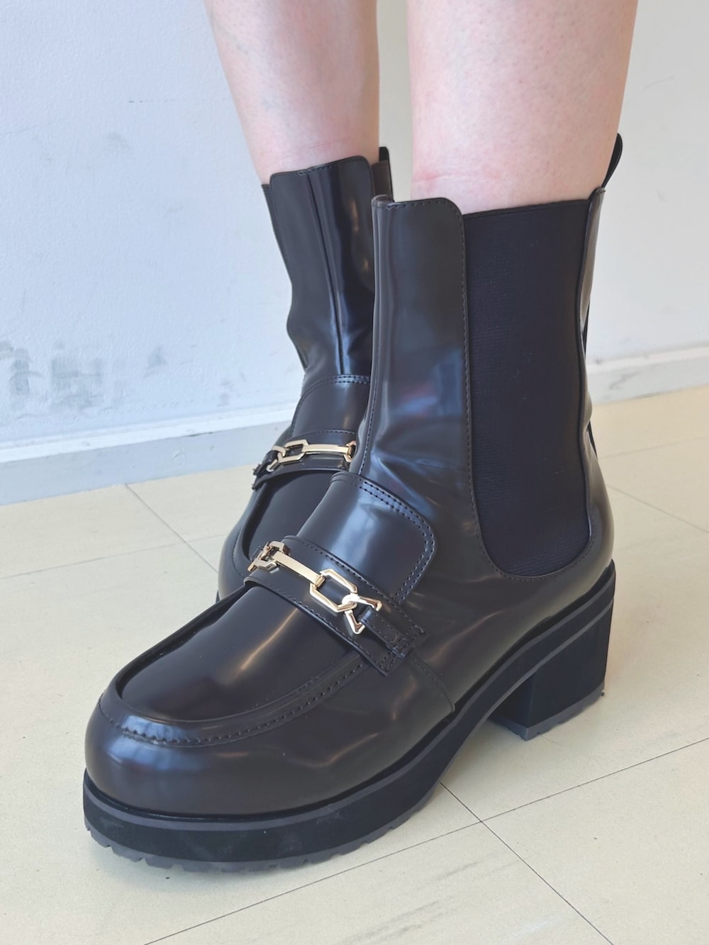 ホワイト系のシャツ/ブラウス、ブラック系のスカート、ブラウン系のブーツを着用したレディースの秋コーディネートの6枚目の写真