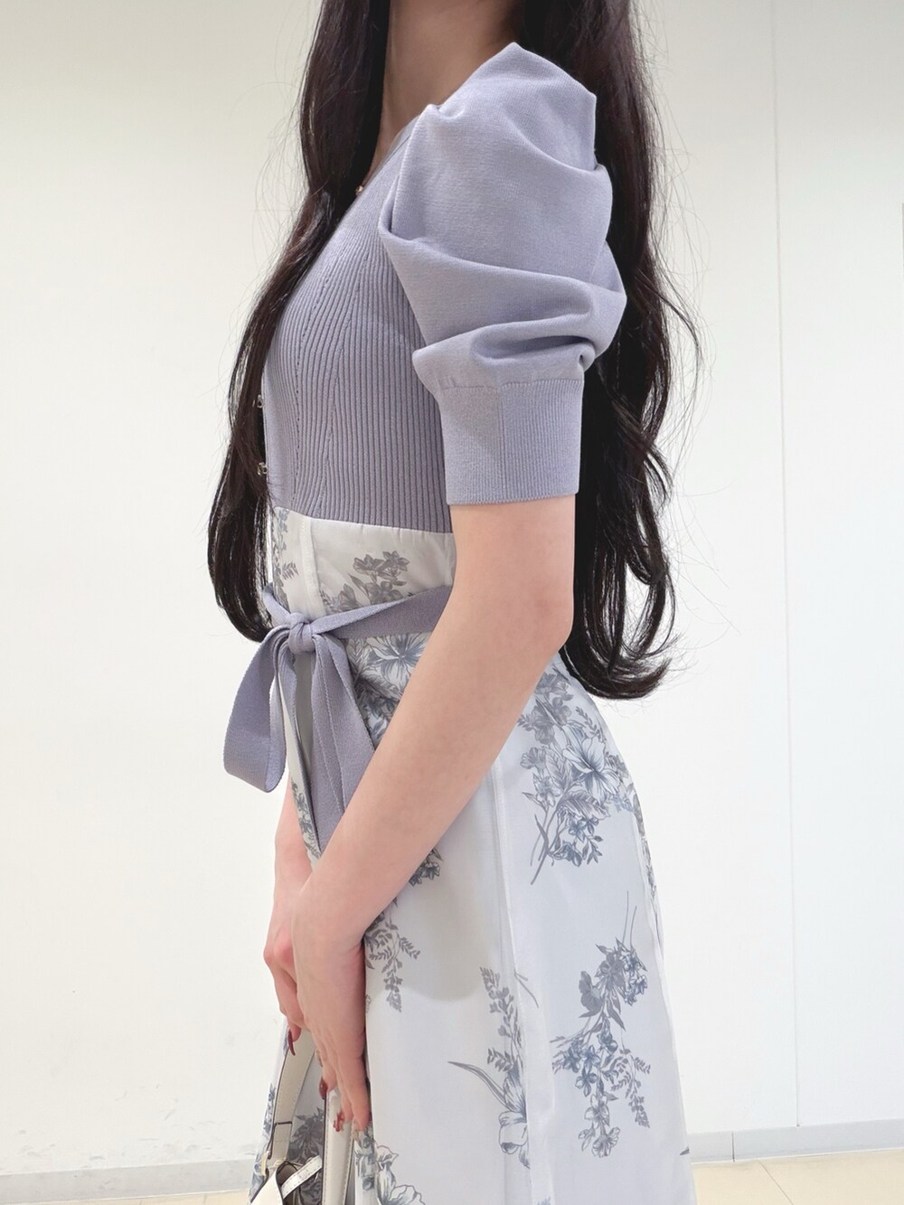 パープル系のワンピース、ホワイト系のショルダーバッグ、ブラウン系のパンプスを着用したレディースの冬コーディネートの5枚目の写真