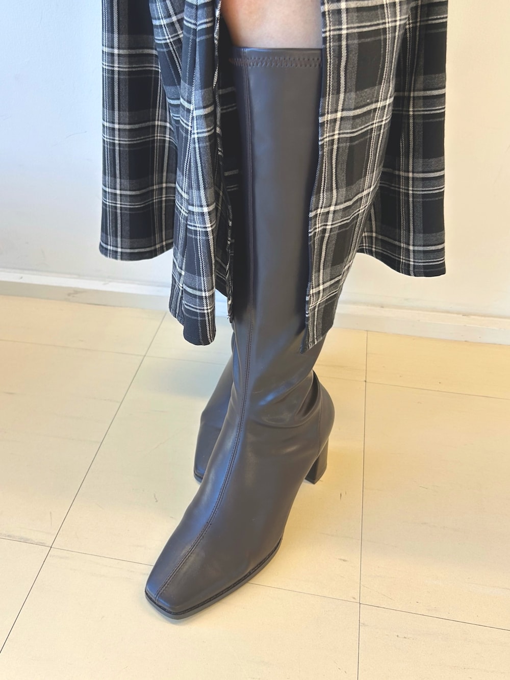 ブラック系のスカート、ホワイト系のムートンコート、ブラウン系のニット/セーターを着用したレディースの秋コーディネートの7枚目の写真