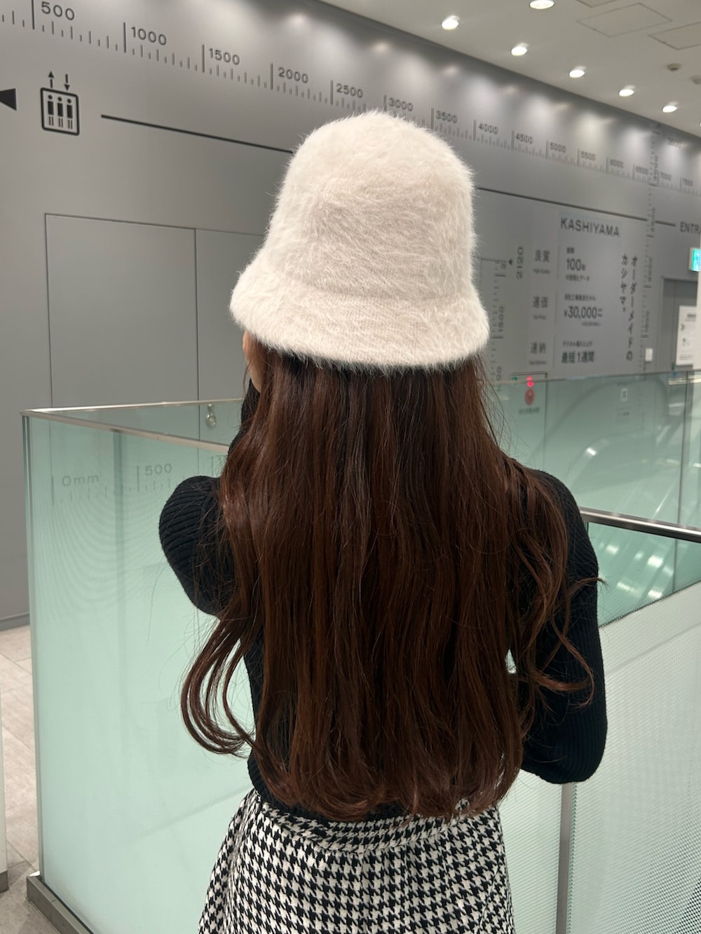 ブラック系のニット/セーター、ブラック系のブーツ、その他のスカートを着用したレディースの冬コーディネートの5枚目の写真