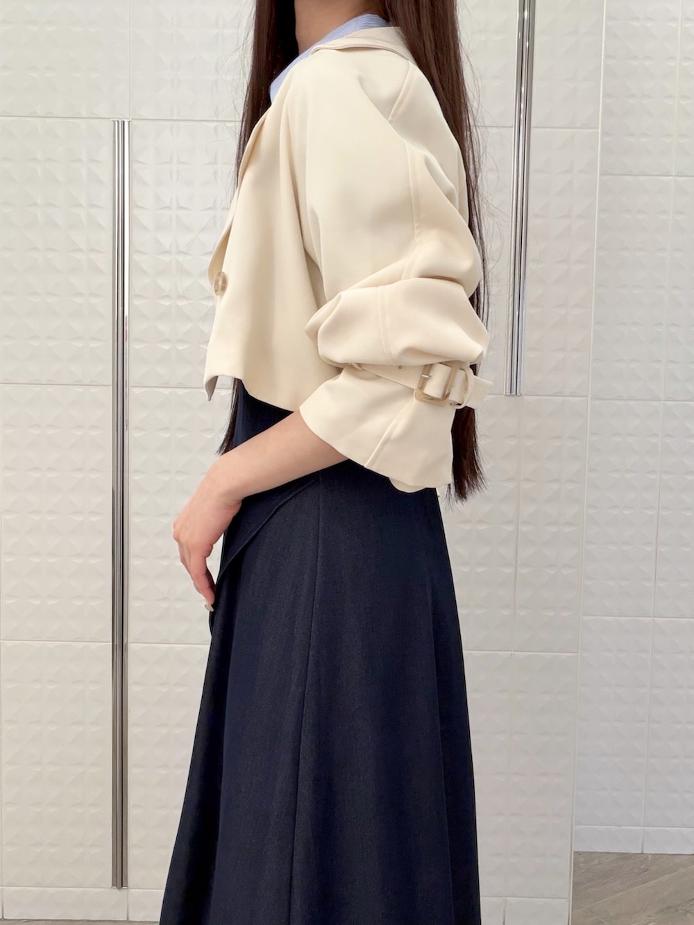 ブルー系のワンピース、ホワイト系のパンプス、ベージュ系のハンドバッグを着用したレディースの春コーディネートの6枚目の写真