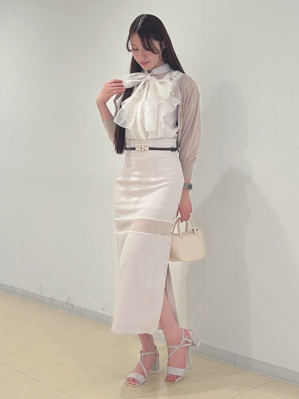 ピンク系のスカート、ホワイト系のシャツ/ブラウス、ベージュ系のカーディガン/ボレロを着用したレディースの春コーディネートの3枚目の写真
