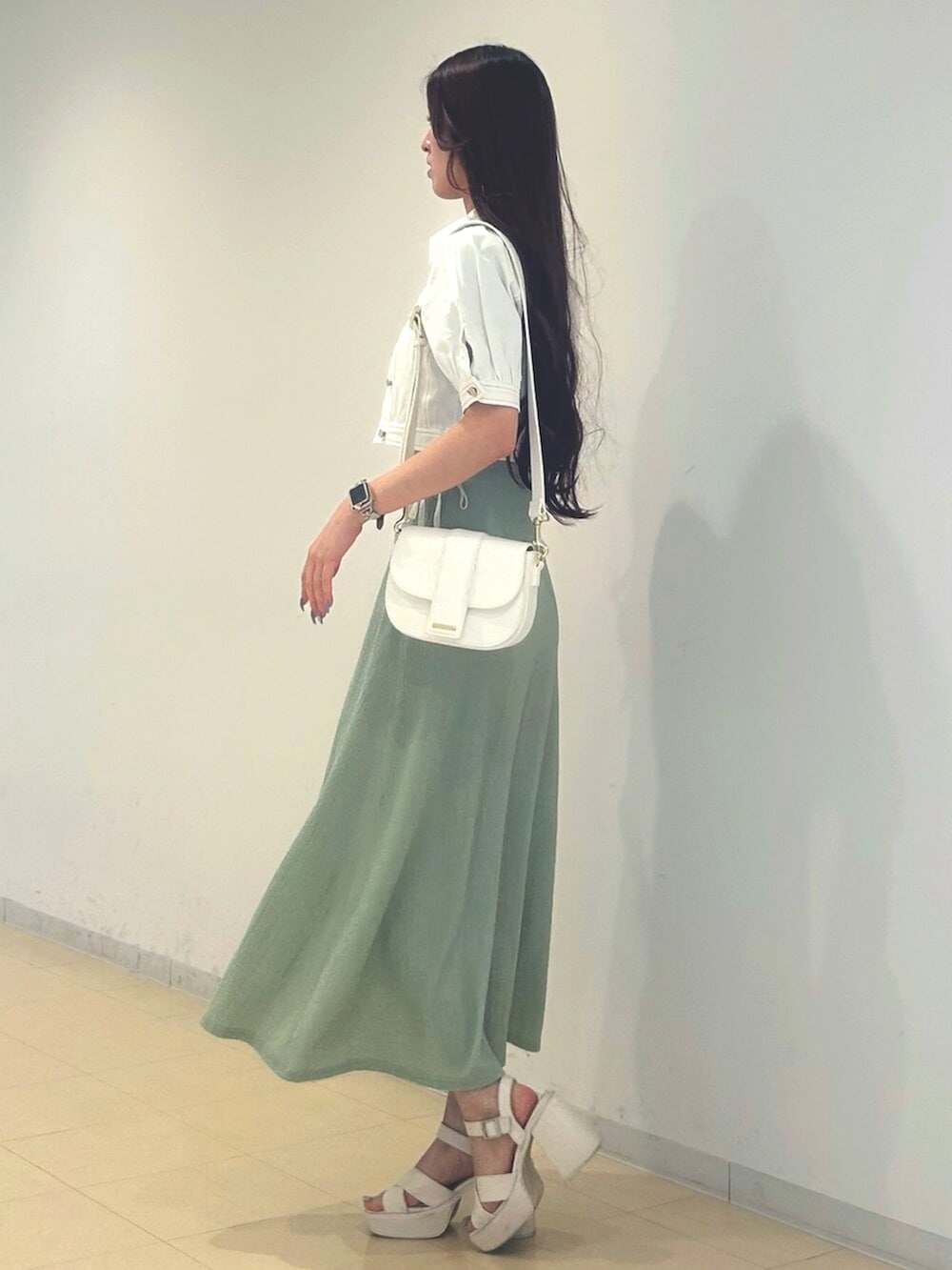 ホワイト系のサンダル、ホワイト系のショルダーバッグ、ホワイト系のデニムジャケットを着用したレディースの夏コーディネートの2枚目の写真