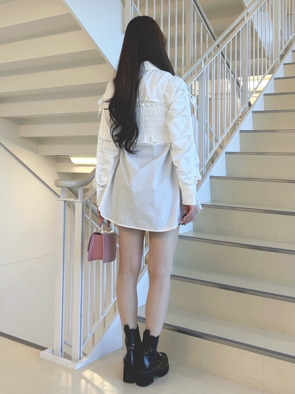 ホワイト系のシャツ/ブラウス、グレー系のスカート、ピンク系のハンドバッグを着用したレディースの秋コーディネートの4枚目の写真