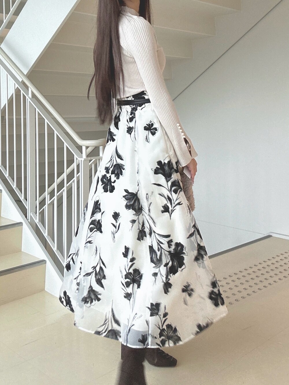 ホワイト系のスカート、ベージュ系のニット/セーター、ピンク系のハンドバッグを着用したレディースの秋コーディネートの7枚目の写真