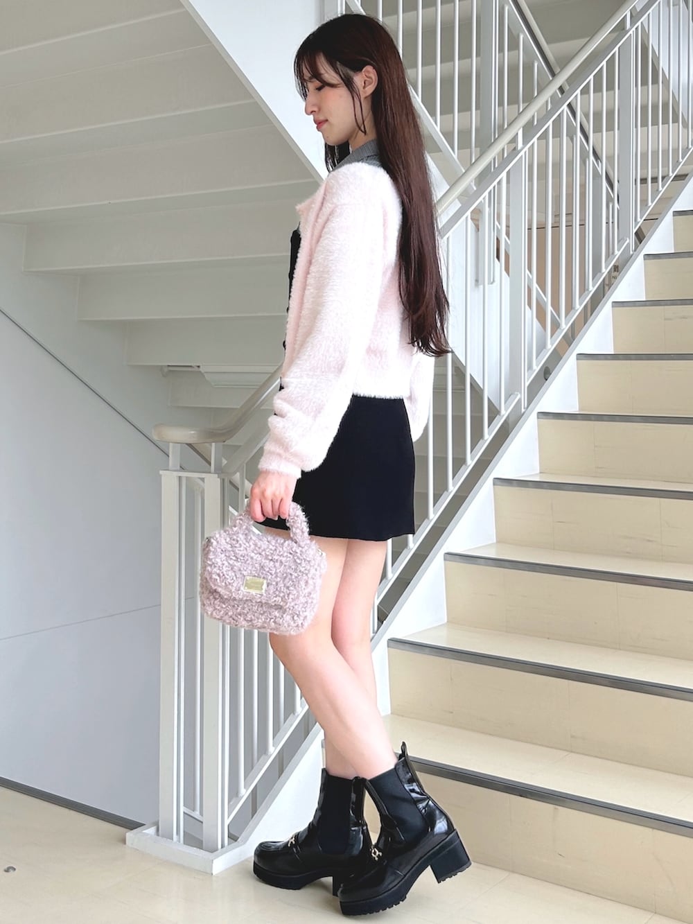 その他のワンピース、ピンク系のハンドバッグ、ブラック系のブーツを着用したレディースの秋コーディネートの2枚目の写真